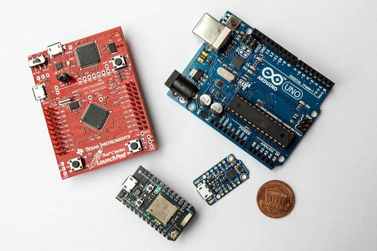 A selection of development boards. Clockwise from top left: Texas Instruments Launch Pad, Arduino Uno R3, Adafruit Trinket 5V, Particle Photon
